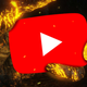 It's a fiery-looking hand clutching the YouTube logo between it's big-ass fingers.